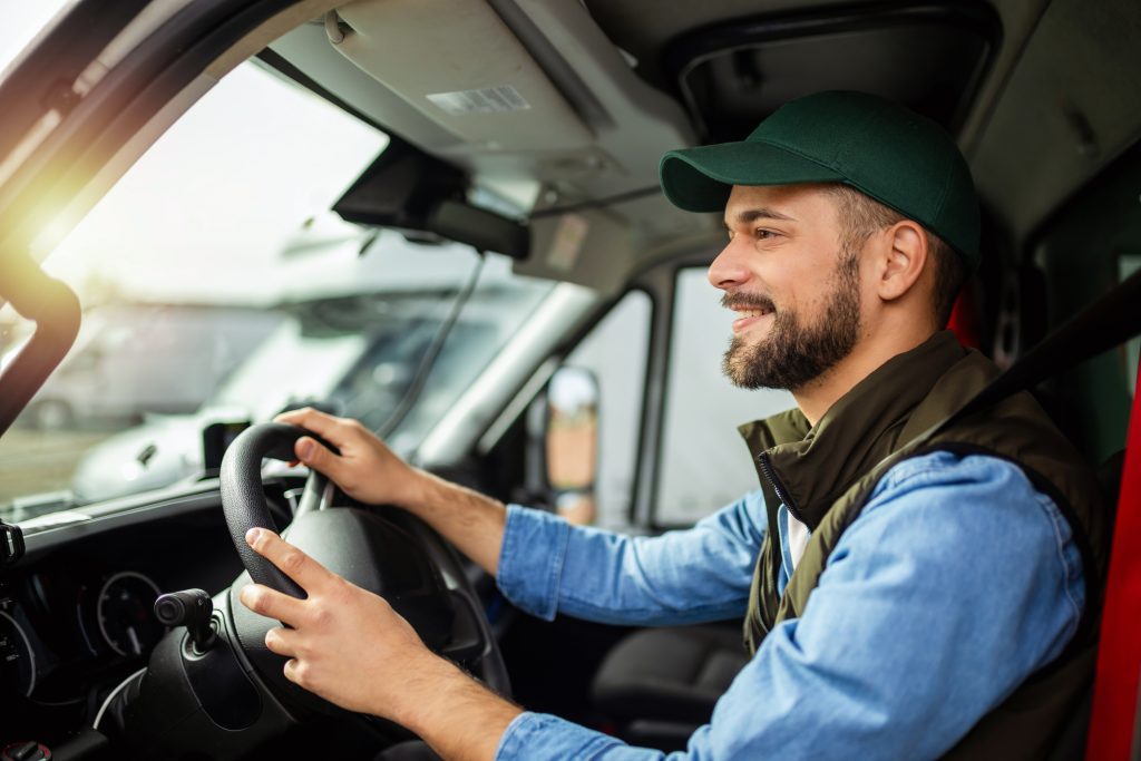 Young man driving his work truck, unaware of the FBT mistakes he's making.