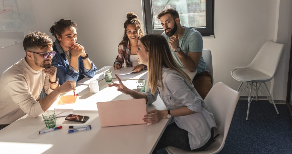 Team of coworkers having a business strategy meeting to discuss the 12-month cash flow forecast.