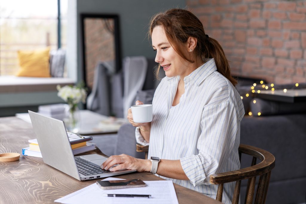 Small business owner using xero accounting software in her home office to stay on top of finances.